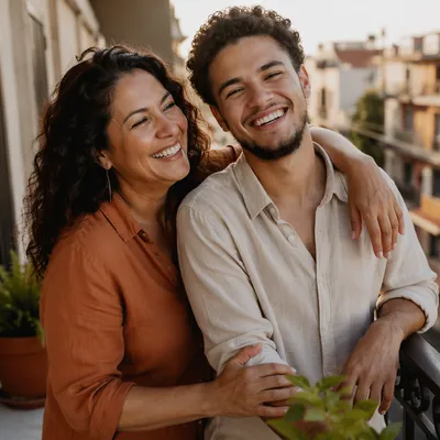 Laughing Adult Siblings on Sunlit Balcony