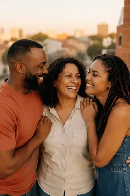 Three Adult Siblings Laughing on Balcony
