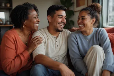 Three Adult Siblings Laughing on Sofa
