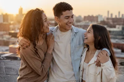 Three Siblings Laughing on Rooftop