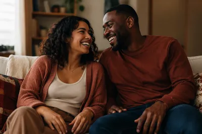 Laughing Adult Siblings on Cozy Sofa