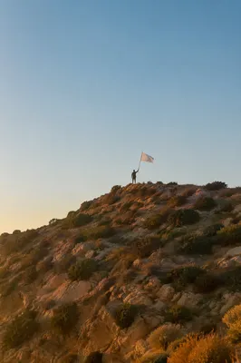 White Surrender Flag at Sunrise Hilltop