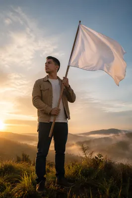 Young Man with White Flag at Sunrise
