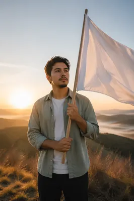 Young Man Holding White Flag at Sunrise