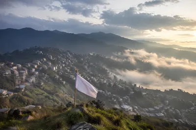 White Surrender Flag Over Misty Sunrise Hills