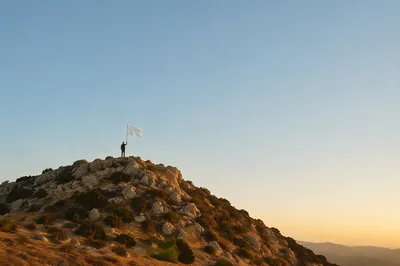 White Surrender Flag at Sunrise Hilltop