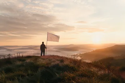 Quiet Surrender with White Flag at Sunrise