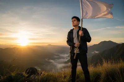 Man Holding White Flag at Sunrise