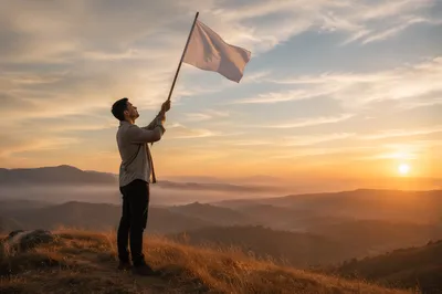 Man Raising White Flag at Sunrise