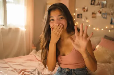 Teen Girl Smiling in Cozy Bedroom