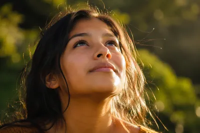 Young Woman Looking Up in Sunlight