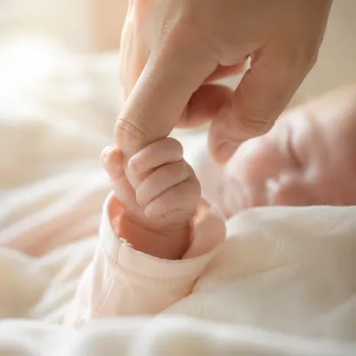 Newborn Hand Holding Parent Finger