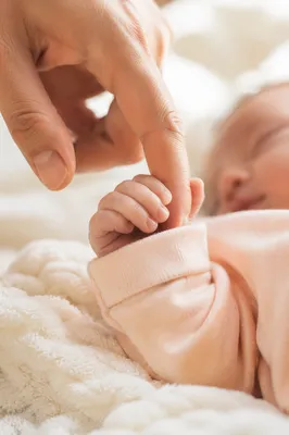 Newborn Hand Holding Parent Finger
