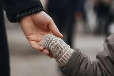 Child Holding Adult Hand in Trust