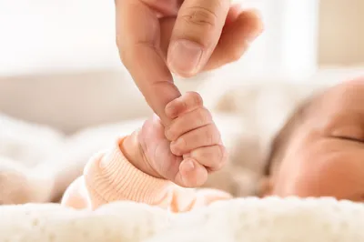 Newborn Hand Holding Parent Finger