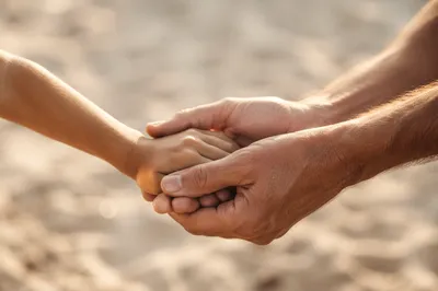 Child Hand Held in Gentle Trust