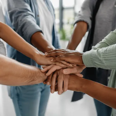 Diverse Hands Stacked in Hopeful Unity