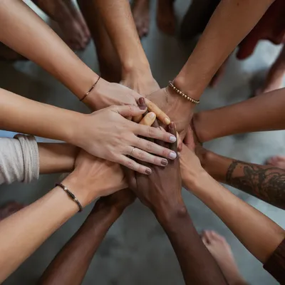 Diverse Hands Stacked in Hopeful Unity
