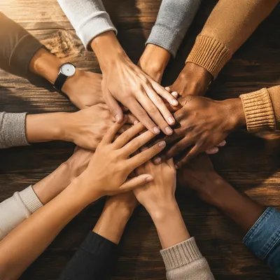 Diverse Hands United on Wooden Table
