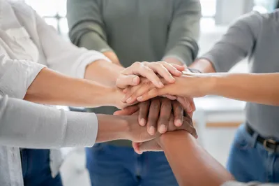Diverse Hands Stacked in Hopeful Unity