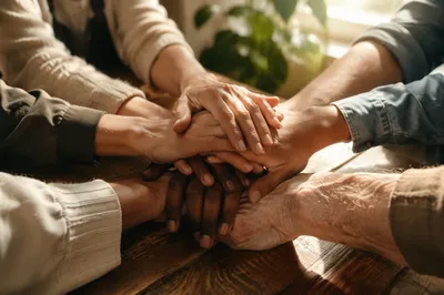Many Hands Stacked in Warm Unity