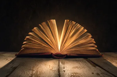Wisdom Book Glowing With Golden Light