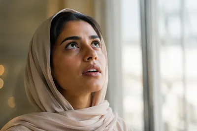 Awestruck Woman Looking Up by Window