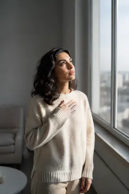 Hopeful Woman Looking Up by Window