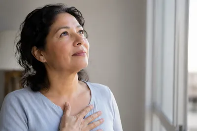 Hopeful Woman Looking Up by Window