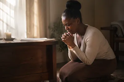 Young Woman Kneeling in Prayer