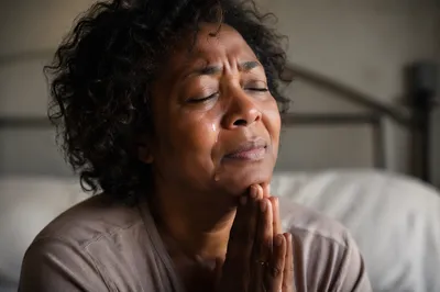 Tearful Woman Praying in Soft Light