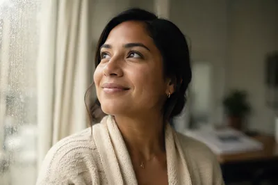 Hopeful Young Woman by Rainy Window