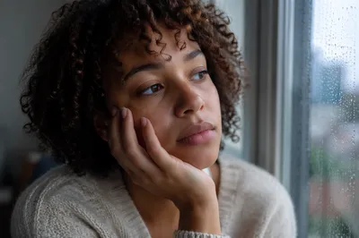 Thoughtful Young Adult by Rainy Window