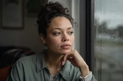 Thoughtful Young Adult by Rainy Window