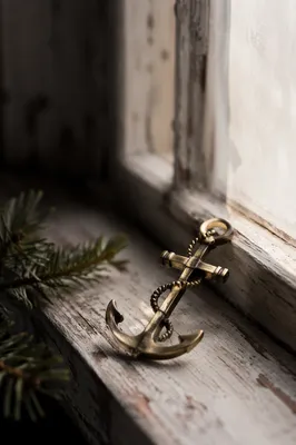 Aged Brass Anchor Cross by Window