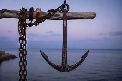 Weathered Anchor Cross at Twilight Sea