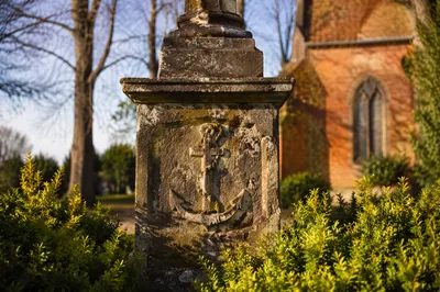 Weathered Anchor Cross Monument in Churchyard