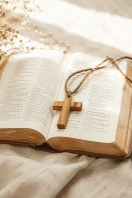 Wooden Cross on Open Scripture and Linen