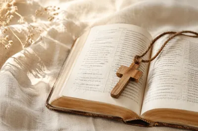 Wooden Cross on Open Bible and Linen