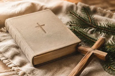 Bible and Wooden Cross on Linen