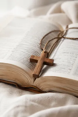 Wooden Cross on Open Bible and Linen