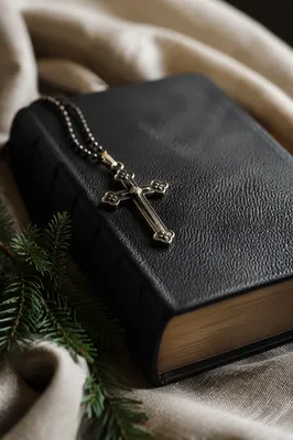 Bible and Bronze Cross on Linen