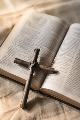 Rustic Cross on Open Bible and Linen