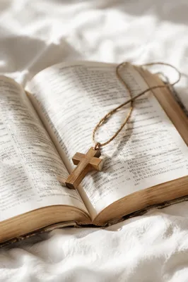 Open Bible with Wooden Cross on Linen