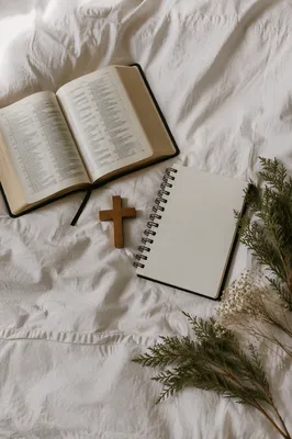 Open Bible and Wooden Cross on Linen