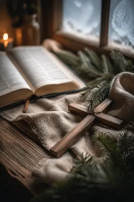 Wooden Cross Beside Bible on Linen