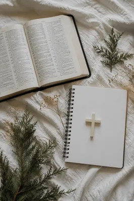 Open Bible and Ivory Cross on Linen