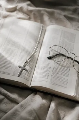 Open Bible with Silver Cross on Linen