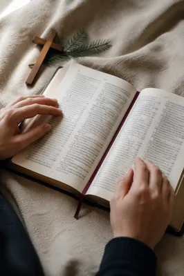 Open Bible with Wooden Cross on Linen