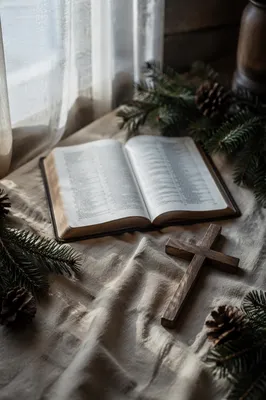 Open Bible and Wooden Cross on Linen